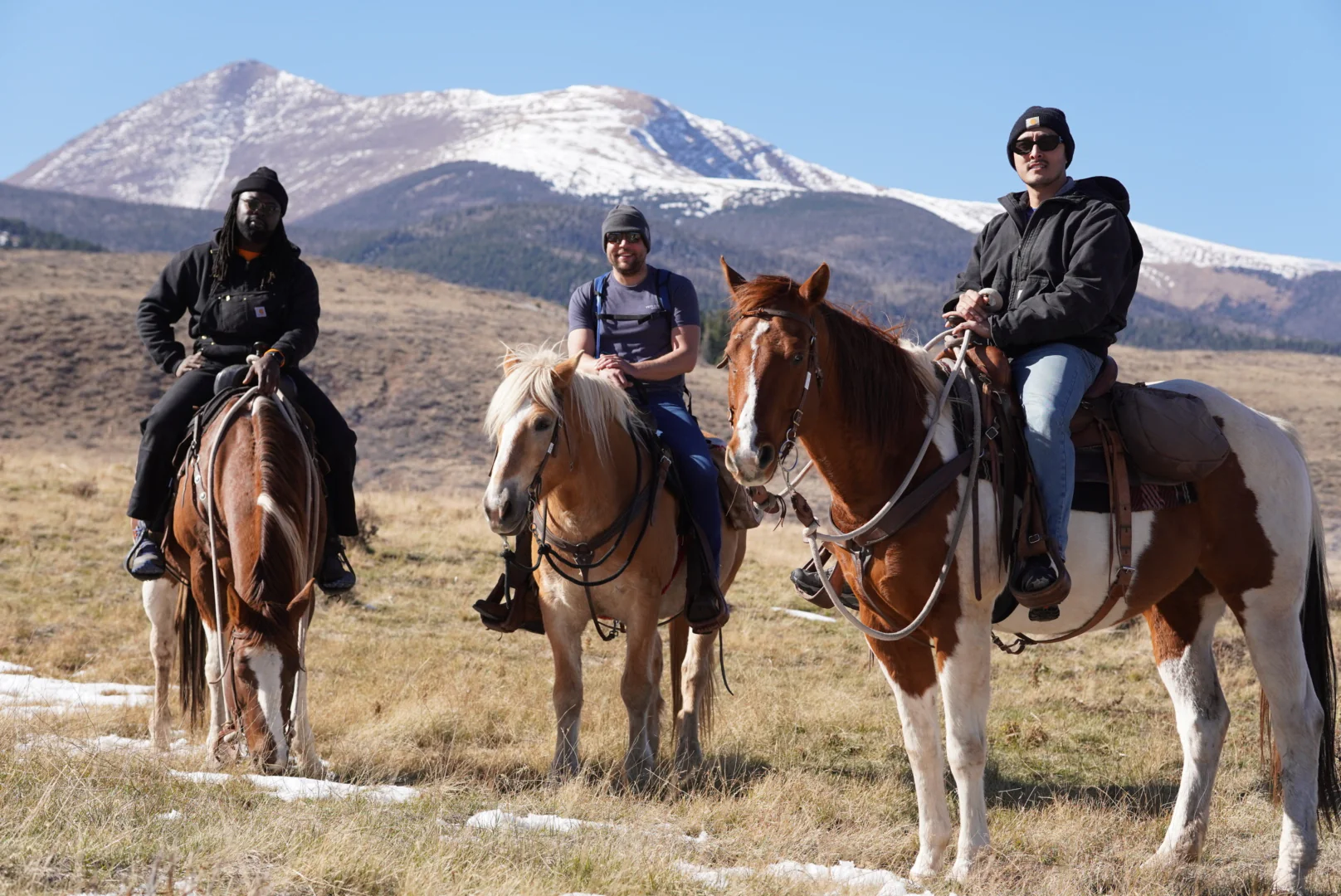 3 men sitting on horses enjoying a day at the ranch