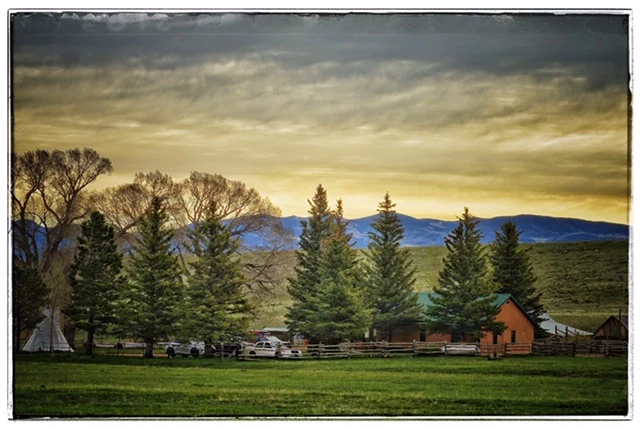 Music Meadows Ranch at Sunset with a trees, mountains, and a tipi