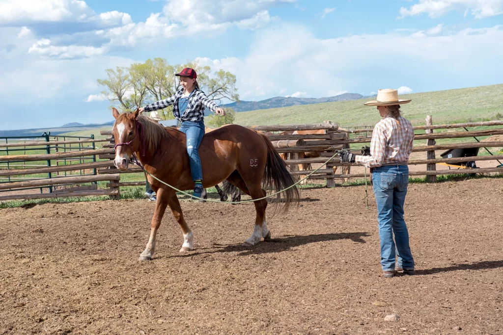 child riding bareback on a horse being led by an adult at Music Meadows Ranch