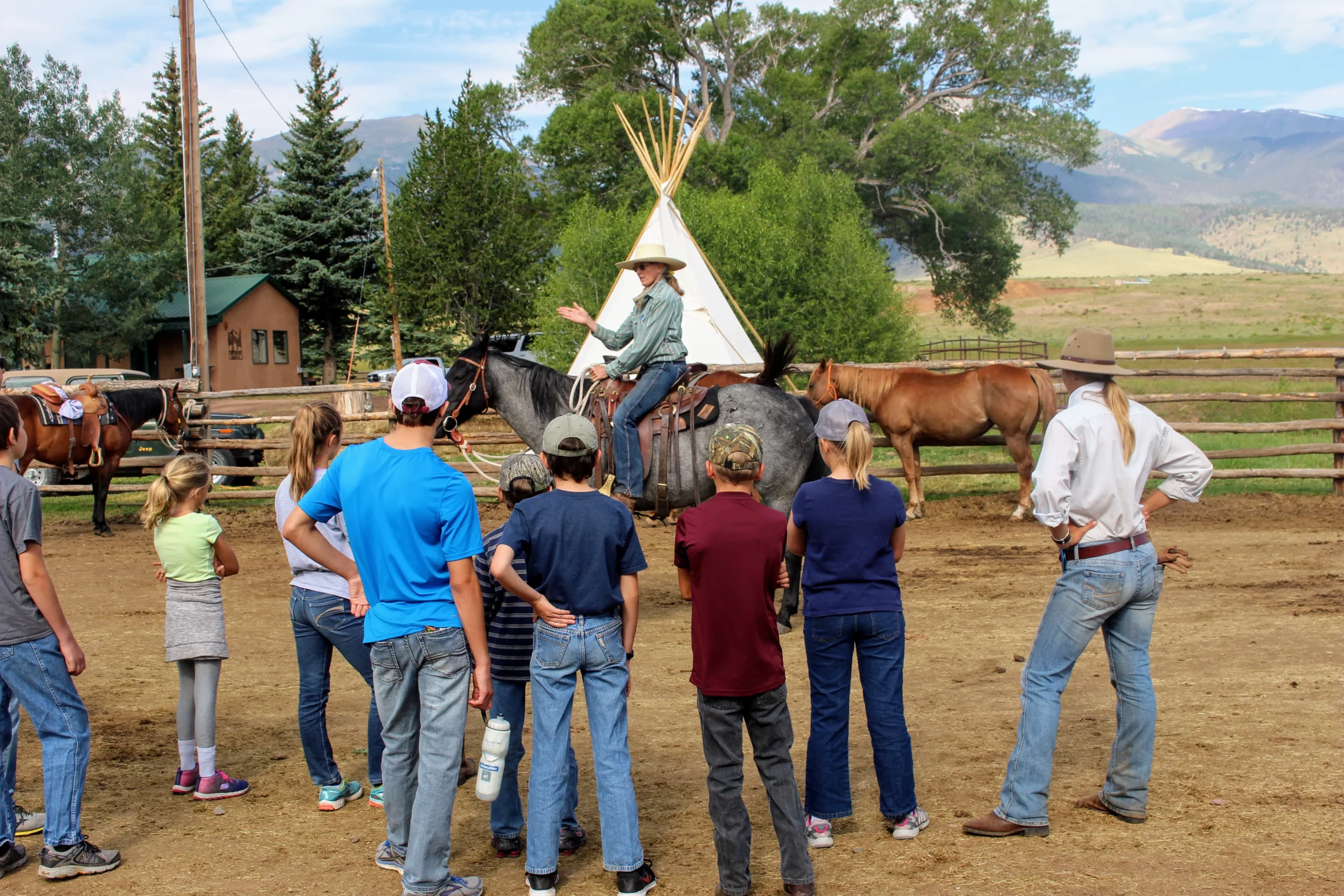 cowgirl instructing a group of people during a day at the ranch at music meadows